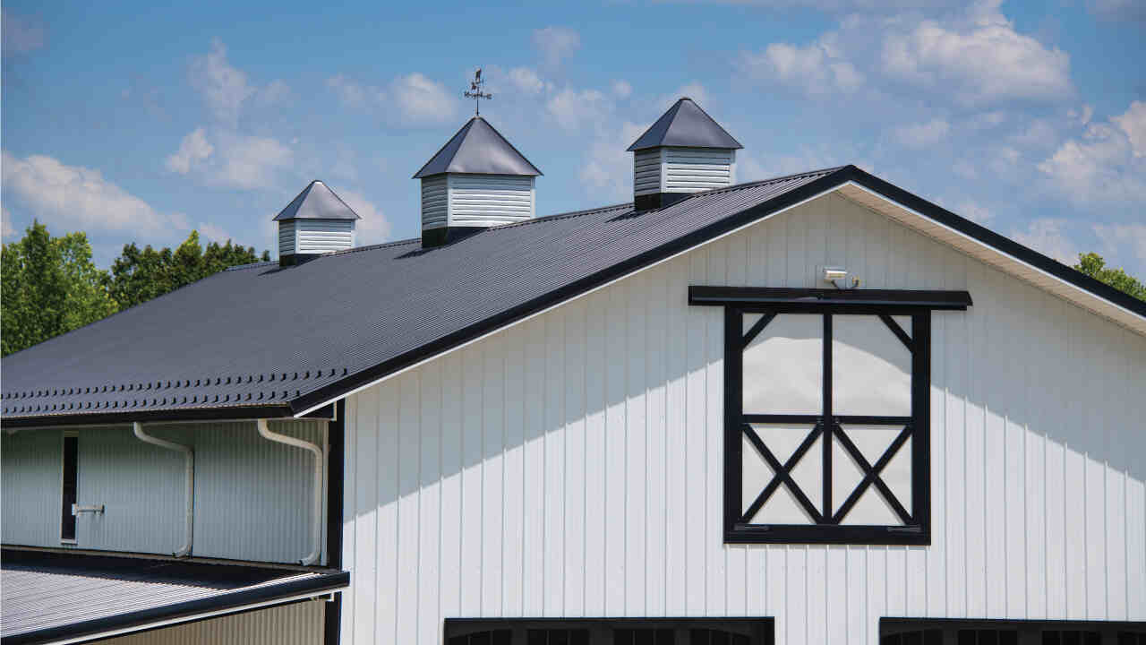 White Barndominium with Black Designs